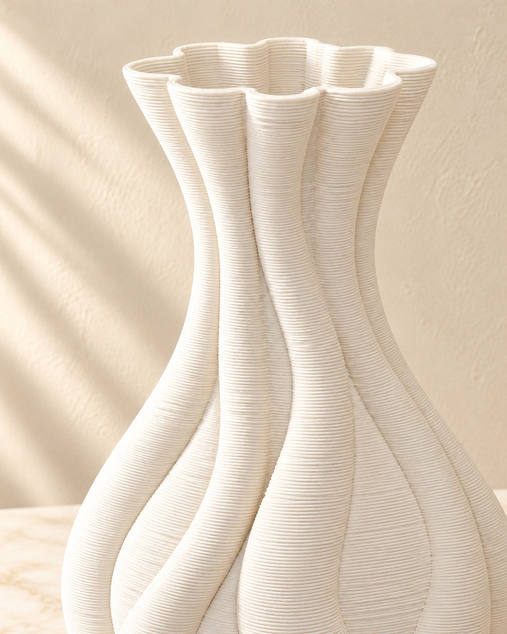 Close-up of Emilie vase twisted flutes, scalloped rim and fine ridged white texture