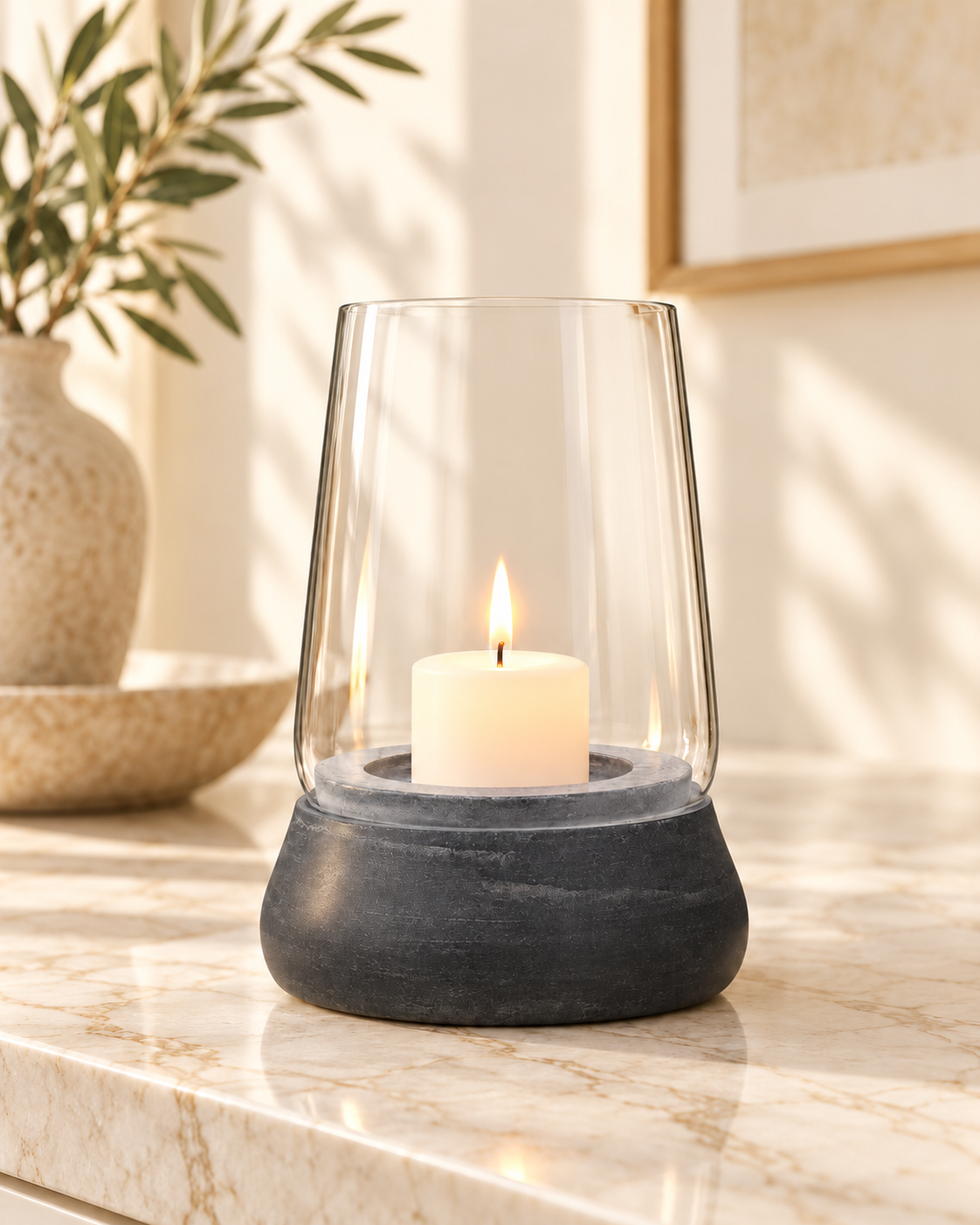 Kira grey marble and clear glass holder styled with an ivory pillar candle on cream marble