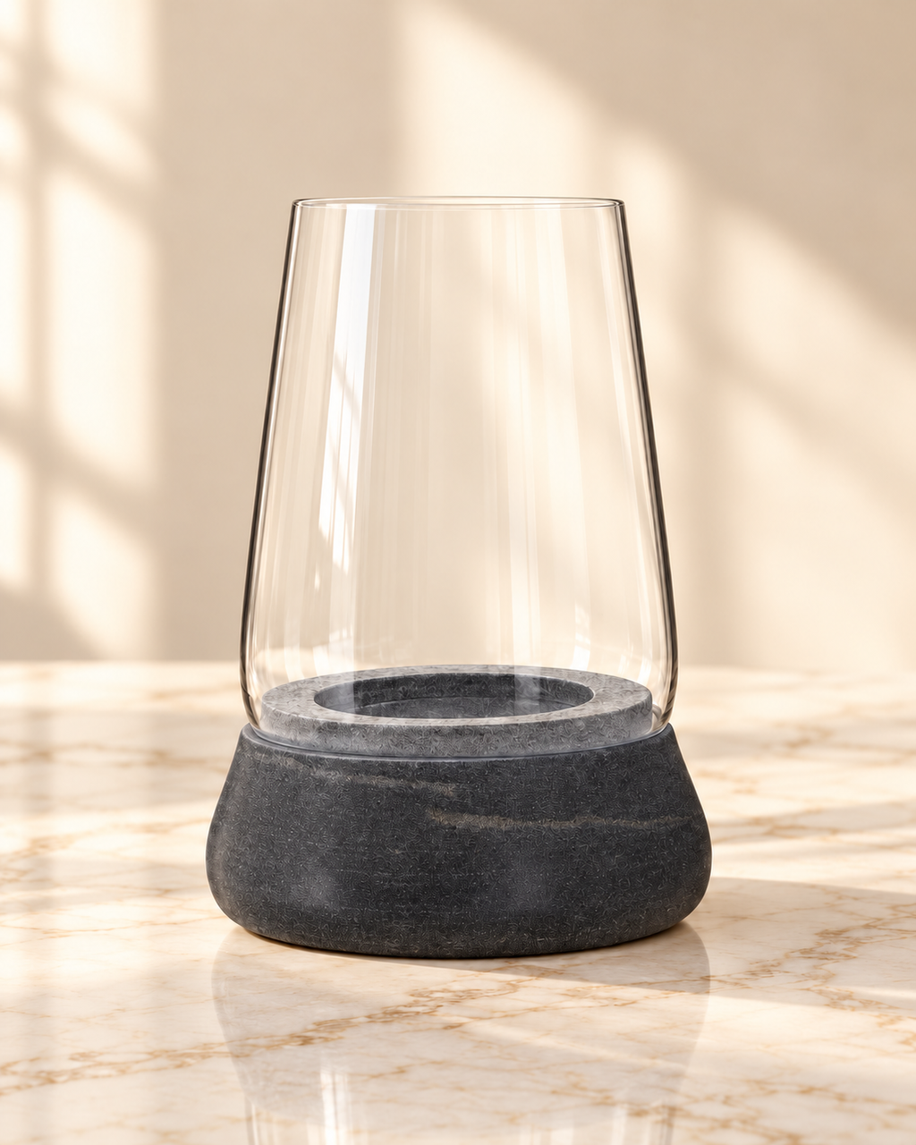 Kira dark grey marble and clear glass candle holder, empty, on cream marble