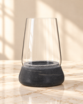 Kira dark grey marble and clear glass candle holder, empty, on cream marble