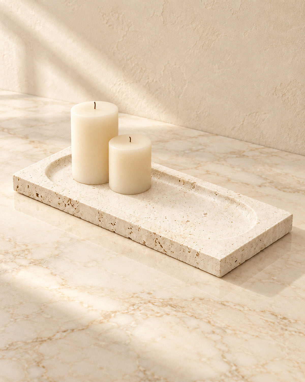 Tibor travertine tray styled with cream candles on cream marble; candles not included